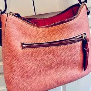 Dooney & Bourke over the shoulder bag. Color Pink and interior lining is red.